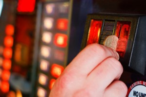 Inserting pound sterling coin into Gaming machine